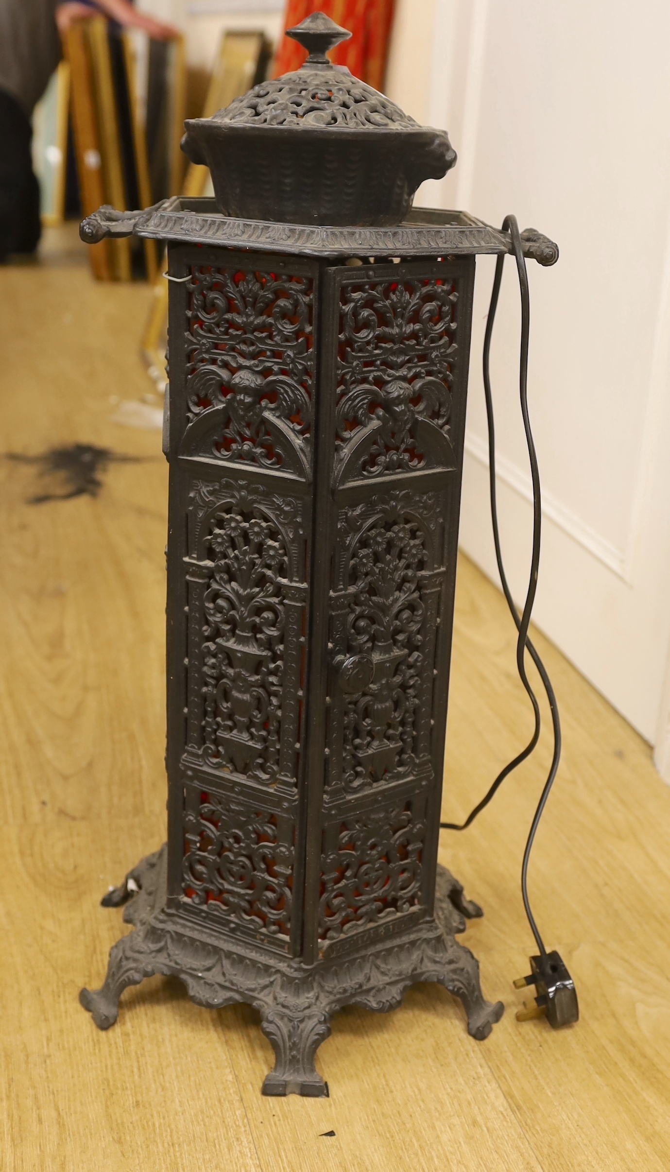 A small cast iron hexagonal stove, 68cm tall